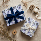 Lavender floral wrapping paper with blue velvet and lace ribbons on gifts by Wrapped Studios.