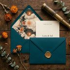 Celestial wedding stationery by Wrapped Studios featuring teal envelopes with vintage sun and moon liners.