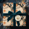 Celestial wrapping paper with a vintage sun and moon design and teal velvet ribbon by Wrapped Studios.