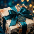 Celestial wrapping paper with a vintage sun and moon pattern and teal satin ribbon from Wrapped Studios.