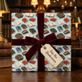 Vintage book wrapping paper with a burgundy velvet ribbon and bookworm gift tag by Wrapped Studios.