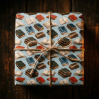 Vintage book lover wrapping paper by Wrapped Studios, tied with twine. Literary gift wrap on a square box.