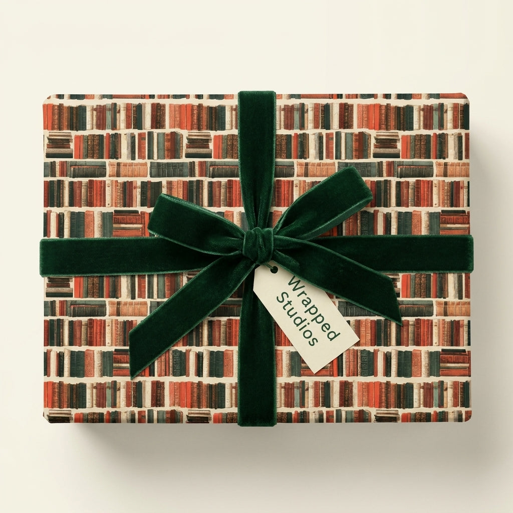 Book lover wrapping paper with bookshelf pattern, green velvet ribbon, and Wrapped Studios tag.