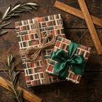 Vintage book wrapping paper with green satin bow and rustic twine by Wrapped Studios.