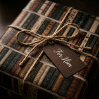 Vintage book wrapping paper for him tied with rustic twine by Wrapped Studios.