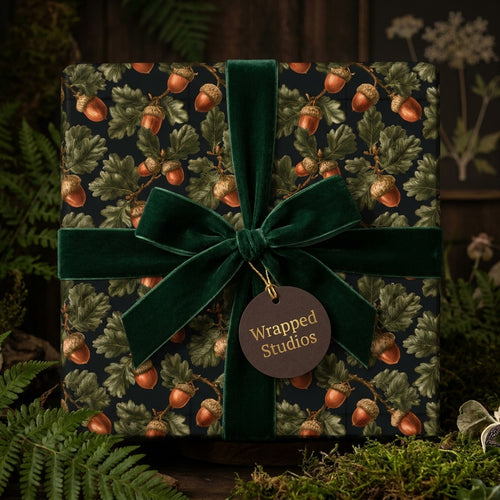 Rustic acorn woodland wrapping paper with a forest green velvet ribbon by Wrapped Studios.