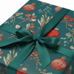 Teal Christmas wrapping paper with vintage botanical and red ornament pattern, tied with a luxurious green satin ribbon bow.