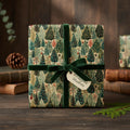Square gift wrapped in rustic woodland forest-themed Christmas wrapping paper with green velvet ribbon.