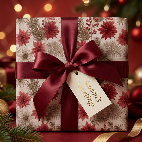 Elegant vintage Christmas wrapping paper with burgundy floral pattern and satin bow by Wrapped Studios.