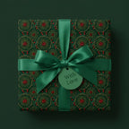 Luxury green floral Christmas wrapping paper by Wrapped Studios, tied with a satin bow and "With Love" tag.