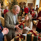 Girl receives a gift in luxury green Christmas wrapping paper with a red bow by Wrapped Studios.