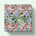 Vintage floral wrapping paper featuring pink lilies and a green ribbon by Wrapped Studios.