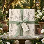 Elegant botanical floral wrapping paper on a wedding gift with sage ribbon by Wrapped Studios.