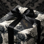 Vintage black and white floral wrapping paper with a luxury satin bow and gift tag by Wrapped Studios.