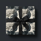 Luxury black and white floral wrapping paper with a black bow on a gift box, by Wrapped Studios.