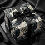 Luxury black and white floral wrapping paper from Wrapped Studios, tied with an elegant black bow.