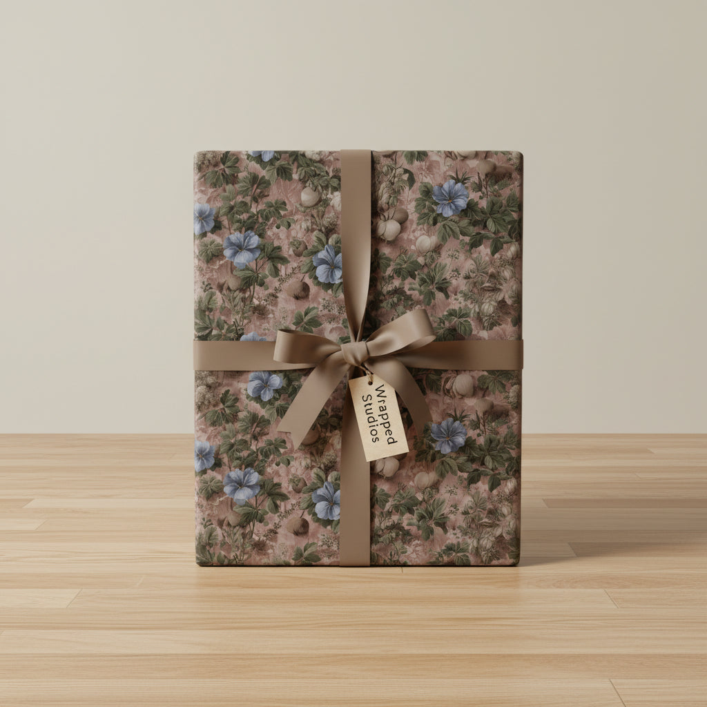 Elegant gift wrapped in vintage floral wrapping paper with blue flowers and a satin ribbon.