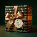Wrapped Studios' vintage apothecary wrapping paper with colorful bottles, tied with a gold satin bow & 'For You' tag.