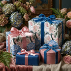 Vintage floral wrapping paper with blue and pink ribbons on luxury gift boxes by Wrapped Studios.