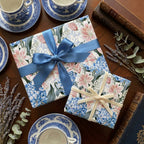 Vintage floral wrapping paper in pink and blue with elegant satin ribbons, by Wrapped Studios.