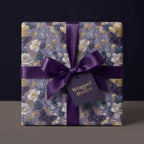 Luxury purple floral wrapping paper with butterflies and satin ribbon by Wrapped Studios.