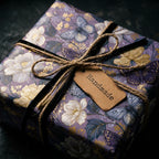Luxury purple floral wrapping paper with gold butterflies and handmade tag by Wrapped Studios.