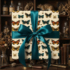 Elegant butterfly print gift wrap with teal satin ribbon against a vintage study backdrop.