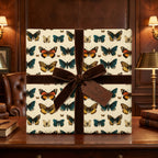Elegant butterfly wrapping paper with brown velvet ribbon and a "With Gratitude" tag.