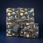 Celestial winter solstice wrapping paper with grey velvet ribbons by Wrapped Studios.