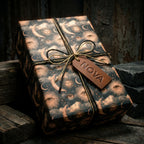 Mystical celestial wrapping paper with vintage moon and sun patterns on a gift box by Wrapped Studios.