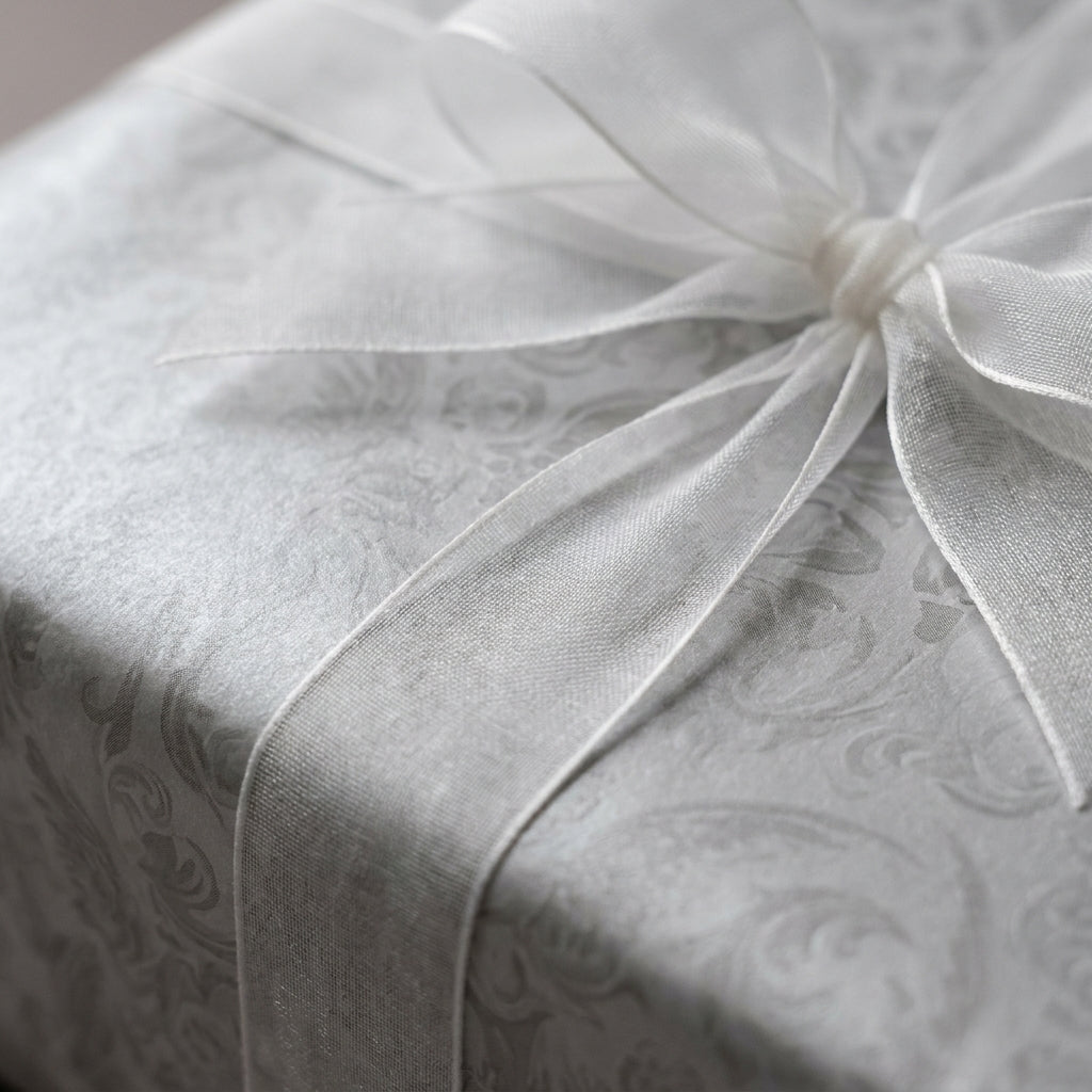 Luxury silver wedding wrapping paper with damask floral pattern and sheer white bow by Wrapped Studios.
