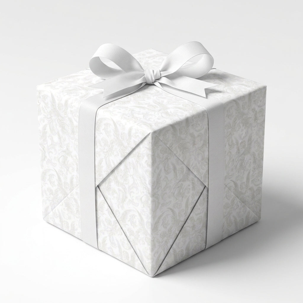 Elegant white floral wedding wrapping paper with a white ribbon bow on a gift box by Wrapped Studios.