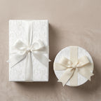 Elegant white wedding wrapping paper with luxury damask pattern and cream bows by Wrapped Studios.