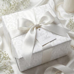 Elegant white damask wedding wrapping paper with satin bow and Mr. & Mrs. tag by Wrapped Studios.