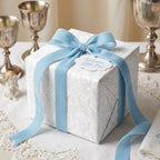 Luxury baby shower wrapping paper with blue velvet ribbon and 'Welcome Little One' tag by Wrapped Studios.
