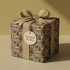 Equestrian Christmas wrapping paper by Wrapped Studios with golden horses, holiday trees, and a beige ribbon.