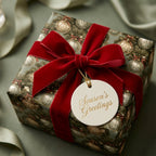 Elegant green Christmas gift wrap with gold ornament pattern and red velvet bow by Wrapped Studios.