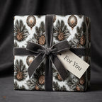 Luxury Christmas gift wrap with a vintage pinecone pattern and grey velvet bow by Wrapped Studios.