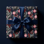 Luxury navy blue Christmas wrapping paper with red ornaments and a satin bow, by Wrapped Studios.