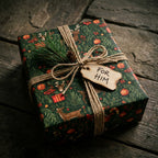 Rustic green Christmas wrapping paper with deer, tied with twine and 'For Him' tag by Wrapped Studios.