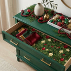 Luxury Christmas wrapping paper with festive pine pattern lining a dresser drawer by Wrapped Studios.