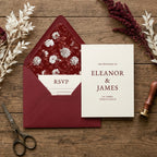 Elegant burgundy floral envelope liner and wedding invitation mockup on rustic wood by Wrapped Studios.