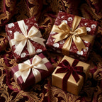 Luxury burgundy floral wrapping paper and gold Christmas gift wrap with bows by Wrapped Studios.