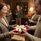 Exchanging a holiday gift in elegant burgundy floral wrapping paper with a cream bow, by Wrapped Studios.