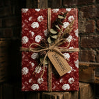 Rustic Christmas gift wrap in vintage burgundy floral pattern with twine and handmade tag by Wrapped Studios.