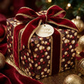 Elegant Christmas wrapping paper with a red berry pattern, velvet ribbon, and holiday tag by Wrapped Studios.