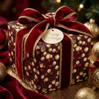 Elegant Christmas wrapping paper with a red berry pattern, velvet ribbon, and holiday tag by Wrapped Studios.