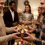 Friends exchanging a gift wrapped in luxury burgundy and gold Christmas wrapping paper by Wrapped Studios.