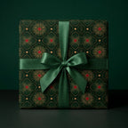 Luxury Christmas wrapping paper in green and gold art deco pattern with satin bow by Wrapped Studios.
