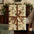 Vintage Christmas gift wrap with botanical holly pattern and brown velvet ribbon by Wrapped Studios.